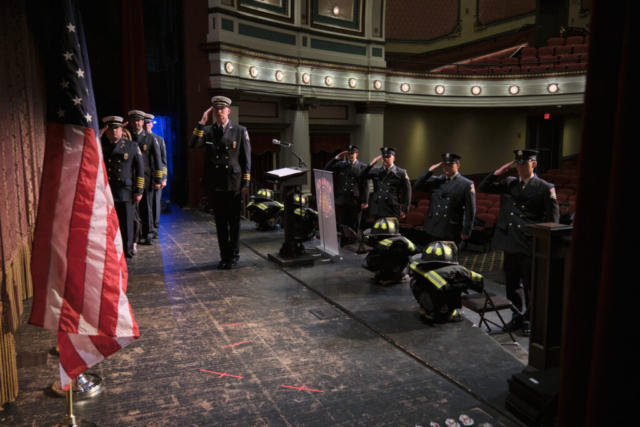 Goshen Firefighters salute the flag during a Recruit Academy graduation ceremony for Charles Hoderbaum, Brian Guerra, Jeffery Gill and Ryan Rentfrow at Goshen Theater on Wednesday, April 2, 2025. (Photo credit: James Korn | Eyedart)