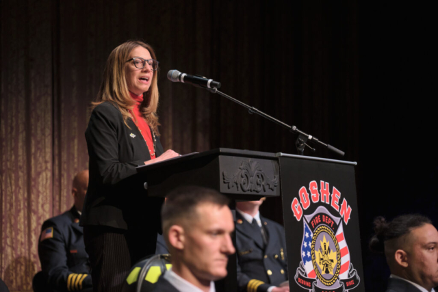 Goshen Mayor Gina Leichty addresses attendees of Fire Department Recruit Academy graduates Charles Holderbaum, Brian Guerra, Jeffery Gill and Ryan Rentfrom during a ceremony on Wednesday, April 2, 2025 at the Goshen Theater. (Photo credit: James Korn | Eyedart)