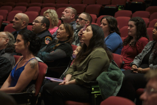 Family members of recent Goshen Fire Deparment recruit training graduates watch the ceremony at Goshen Theater on Wednesday, April 2, 2025. (Photo credit: James Korn | Eyedart)