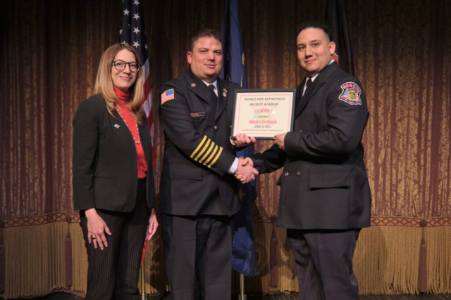 Goshen Fire Cheif Anthony Powell presents GFD Recruit Academy graduate Brian Guerra his certificate along with Mayor Gina Leichty on Wednesday, April 2, 2025 at the Goshen Theater.
