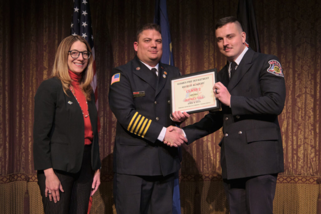Goshen Fire Cheif Anthony Powell presents GFD Recruit Academy graduate Jeffery Gill his certificate along with Mayor Gina Leichty on Wednesday, April 2, 2025 at the Goshen Theater.