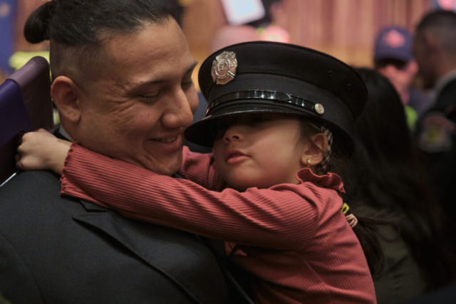 Goshen Fire Deparment Recruit Academy graduate Brian Guerra enjoys a moment with family after a ceremony on Wednesday, April 2, 2025 at Goshen Theater.